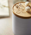 Close up view of Stacked Jewelry Box holding earrings on lid by Yamazaki Home.