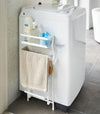 White Magnet Laundry Storage Pockets holding cleaning items in laundry room by Yamazaki Home.