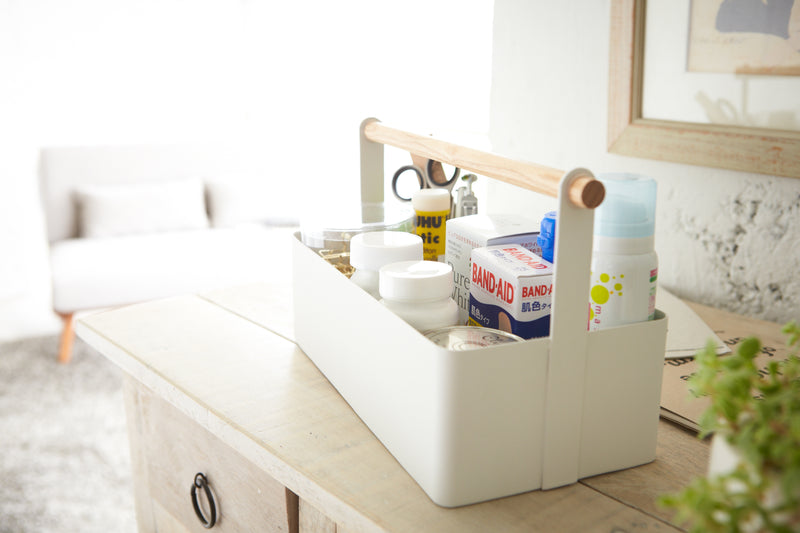 Side view of white Storage Caddy holding first-aid items by Yamazaki Home.