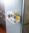 White Magnetic Storage Caddy containing spices and oil on fridge by Yamazaki Home.