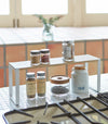 White entryway Stackable Shoe Rack holding shoes by Yamazaki Home.