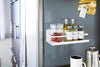 White Magnetic Storage Caddy holding spices in kitchen by Yamazaki Home.