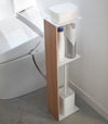 Toilet Paper Stocker holding wipe container, toilet cleaner, and toilet brush in bathroom by Yamazaki Home.