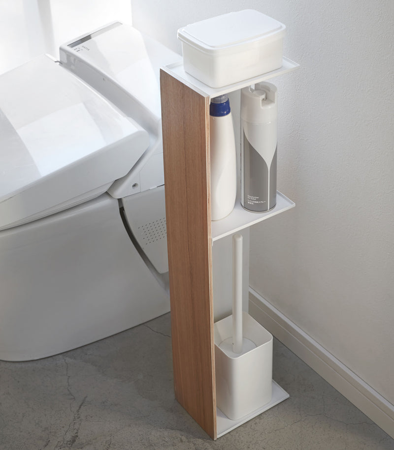 Toilet Paper Stocker holding wipe container, toilet cleaner, and toilet brush in bathroom by Yamazaki Home.