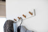 White Wall-Mounted Coat Hanger displaying coat and hat by Yamazaki Home.