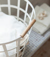 Close up aerial view of white Round Laundry Basket holding clothes by Yamazaki Home.
