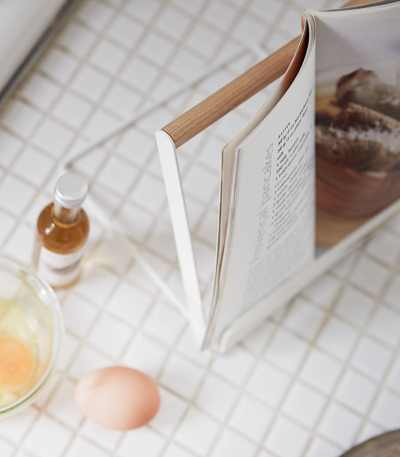White Tablet and Cookbook Stand holding cookbook by Yamazaki home.