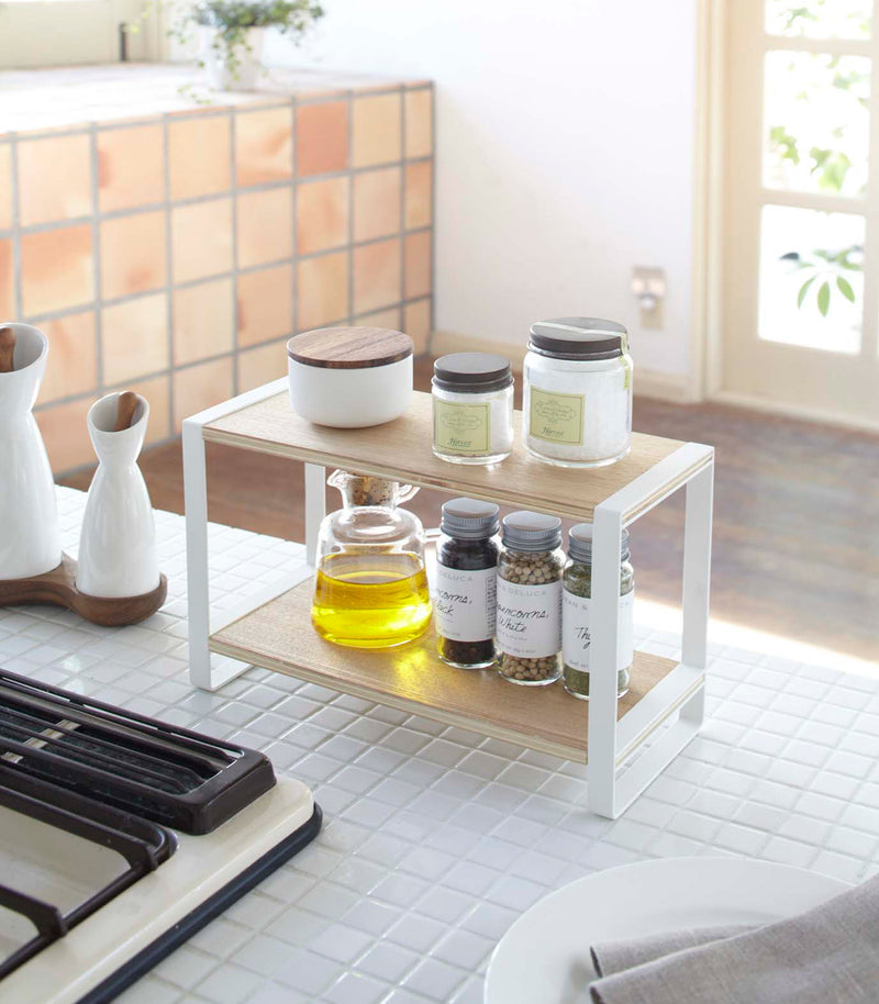 White Countertop Shelf on kitchen counter holding spices and oil by Yamazaki Home.