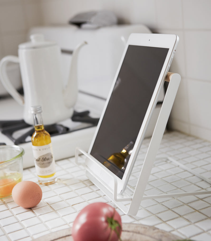 Side view of white Tablet and Cookbook Stand holding a tablet by Yamazaki home.