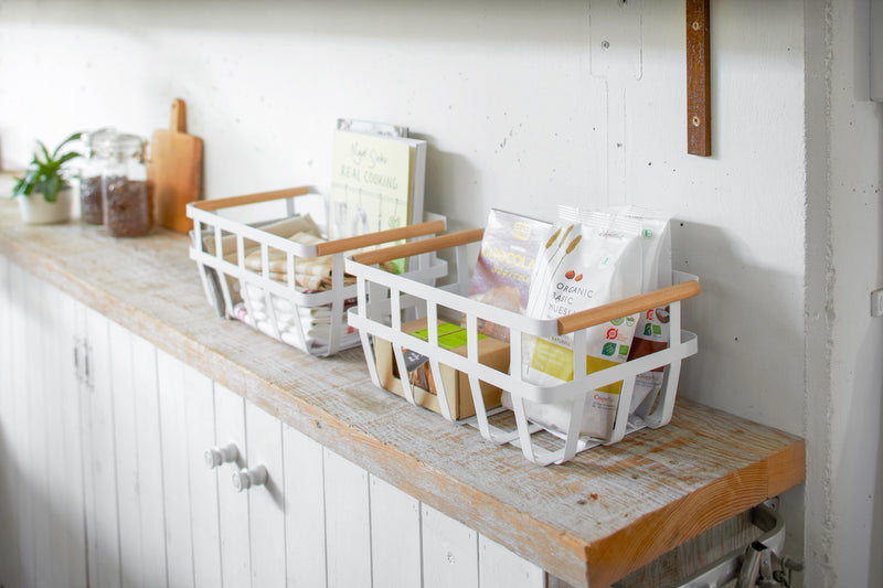 Storage Basket containing food items on shelf by Yamazaki Home.