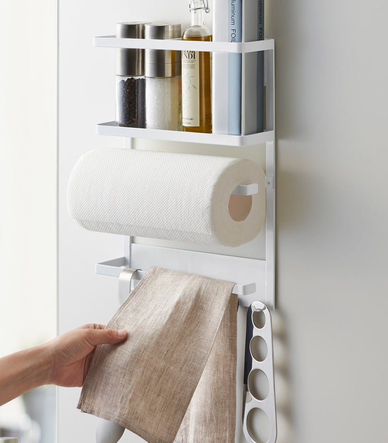 Front view of Magnetic Organizer in kitchen holding towels and spices by Yamazaki home.