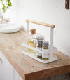 Countertop Storage Caddy displaying oils and spices on counter by Yamazaki Home.