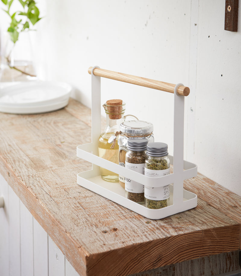 Countertop Storage Caddy displaying oils and spices on counter by Yamazaki Home.