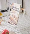 White Tablet and Cookbook Stand on kitchen counter holding cookbook by Yamazaki home.