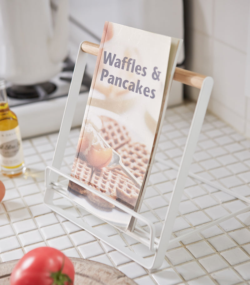 White Tablet and Cookbook Stand on kitchen counter holding cookbook by Yamazaki home.