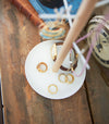 Close up of White Undershelf Hanger holding cookbook by Yamazaki Home.