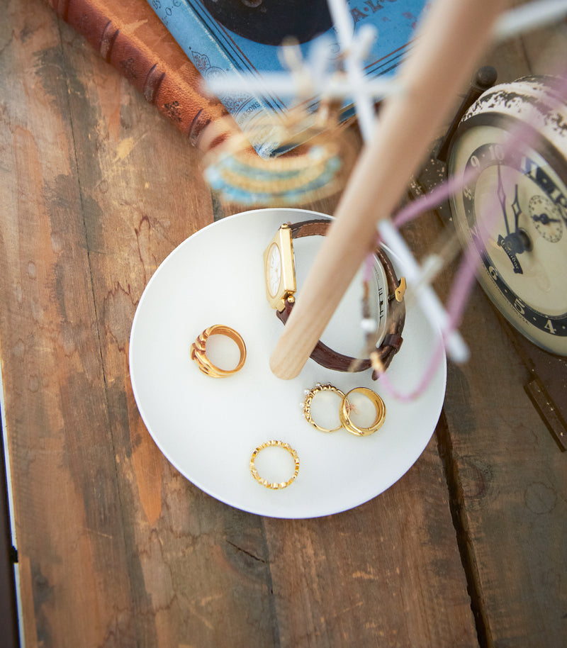 Close up of White Undershelf Hanger holding cookbook by Yamazaki Home.