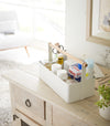 White Storage Caddy containing first-aid items by by Yamazaki Home.