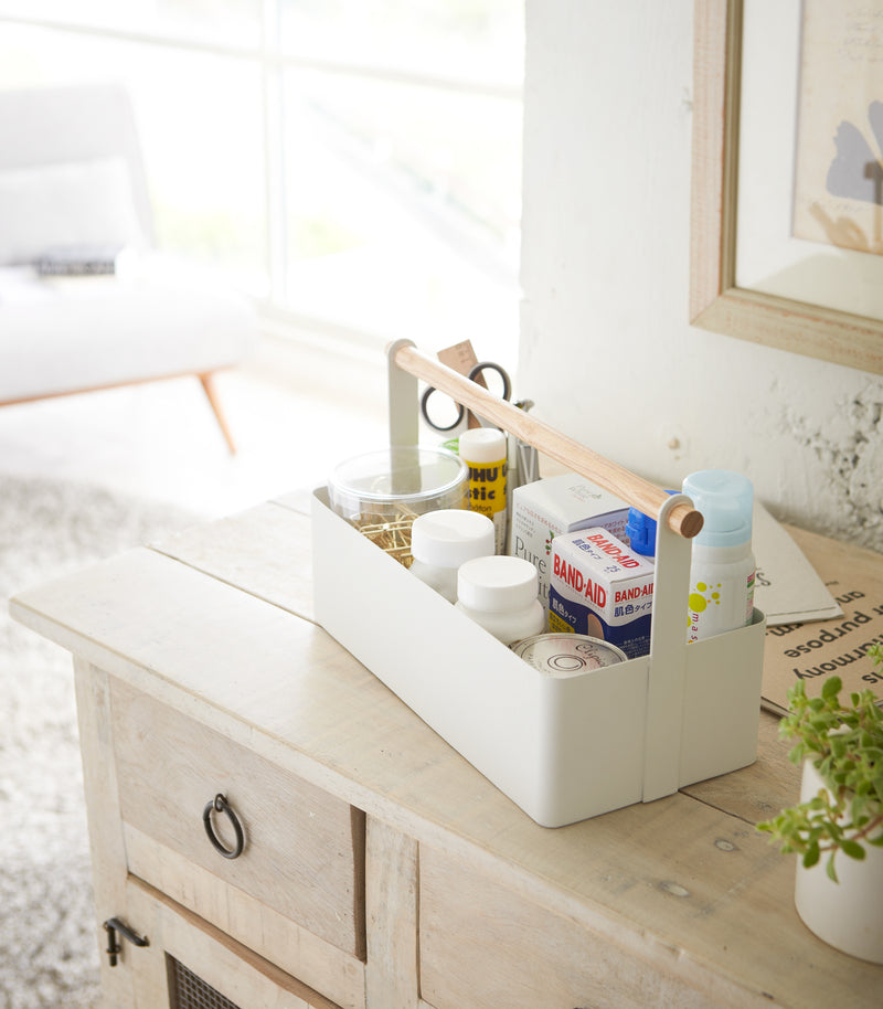 White Storage Caddy containing first-aid items by by Yamazaki Home.