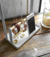 Front view of white Undershelf Stemware Holder holding glasses by Yamazaki Home.