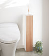 Front view of Toilet Paper Stocker displaying fragrance bottle in bathroom by Yamazaki Home.