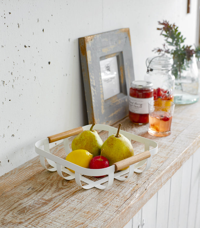 White Fruit Bowl displaying fruit on shelf by Yamazaki Home.