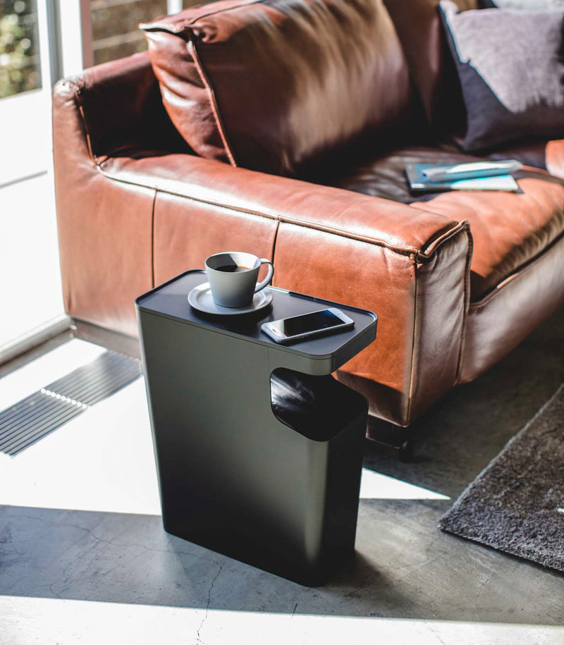 Black Side Table Trash Can displaying cup and phone in living room by Yamazaki Home.