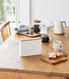 Front view of Coffee Filter Case on dining table by Yamazaki Home.