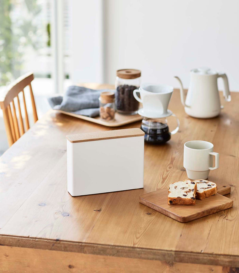 Front view of Coffee Filter Case on dining table by Yamazaki Home.