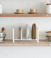 Front view of Wood-Accented Dish Storage Rack displaying plates on kitchen shelf by Yamazaki Home.
