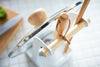 Aerial view of Lid & Ladle Stand holding pot lid and kitchen utensils by Yamazaki Home.