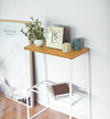White End Table holding plant and décor items by Yamazaki Home.