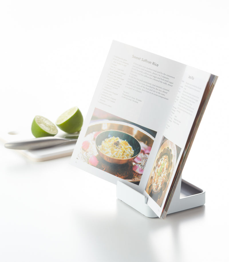 White Lid & Ladle Stand holding cookbook on white background by Yamazaki Home.